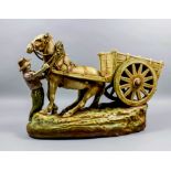 An early 20th Century Austrian Amphora "Blush Ivory" porcelain figure of a horse and cart, 14ins