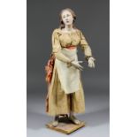 A late 18th Century Neapolitan crib figure of a young woman with a rapt gaze, with terracotta