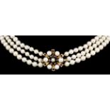 A modern 9ct gold and cultured pearl three strand necklace of graduated form, 450mm overall, with