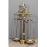 A 19th Century butchers polished brass balance scales with cast bulls head terminal turned column,