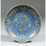 A Chinese cloisonne enamel circular dish, decorated with stylised flowering plants on a blue ground,