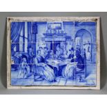 A 19th Century Dutch blue and white tile picture after Jan Steen, painted with a group of people