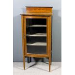 An Edwardian mahogany bow-front dwarf display cabinet with upstand, the whole inlaid with stringings