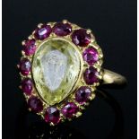 A late Victorian 18ct gold mounted citrine and ruby heart pattern ring, the tear drop shaped citrine