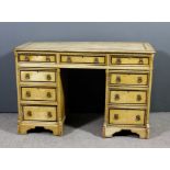 A late Victorian cream painted pine kneehole desk, painted with bandings, the top with moulded edge,