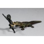 An early 20th Century cold painted bronze figure of a boy and a crocodile, 3.5ins long x 1.375ins