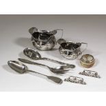 An Edwardian silver milk jug and matching cream jug of rectangular bulbous panelled form with