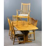 A modern Ercol elm extending dining table with one extra leaf, on solid end supports and trestle