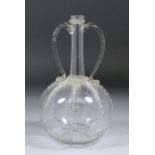 An 18th Century two-handled clear glass "Venise" decanter with eight trailed ribs to the globular