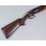 A good 12 bore over and under shotgun by Baikal, Serial No. C01311, with 27.75ins blued steel