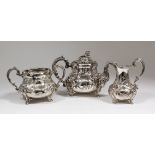 A Victorian silver three piece tea service, the squat baluster shaped bodies boldly embossed and