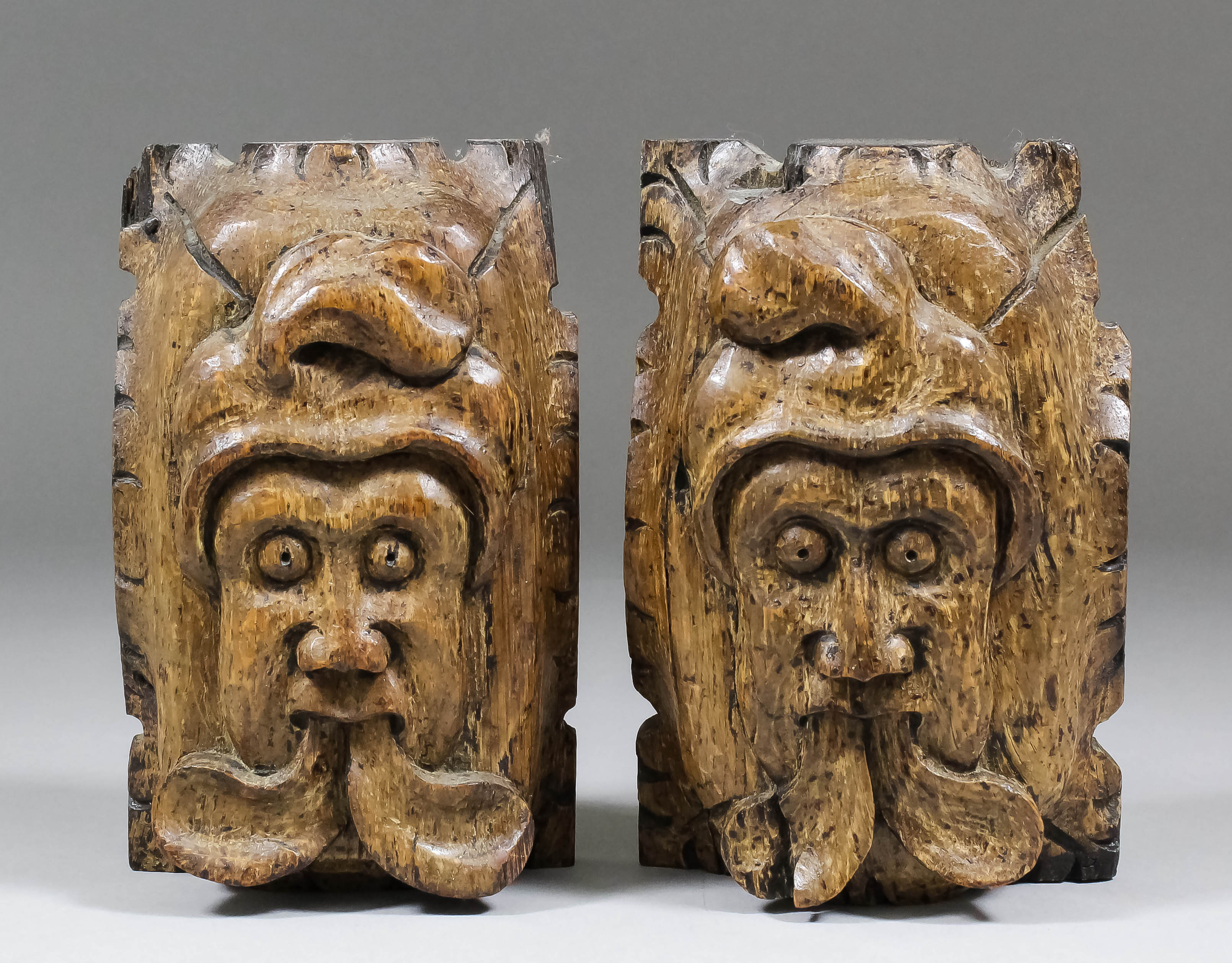 A pair of rare 14th Century English oak heads with divided tongues, each 6.5ins x 4ins x 2ins deep