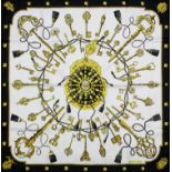 A Hermes gold, white and black "Les Cles" silk scarf, 35ins square, with box