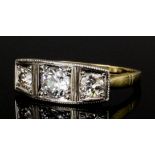 A modern gold and silvery coloured metal mounted three stone diamond ring, the central brilliant cut