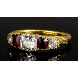 A late Victorian gold coloured metal mounted ruby and diamond five stone ring, the central old cut