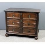 A 17th Century panelled oak chest, with dentil moulded edge to the top, fitted three long drawers