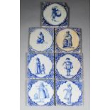 Seven early 17th Century Delft blue and white tiles with figures and fretwork corners, each 5.