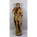 A mid 16th Century carved oak figure of a falconer standing on a moulded bracket, traces of early