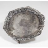A late Victorian silver circular waiter with leaf scroll, gadroon and floral cast rim, the centre