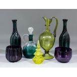 A pair of 19th Century deep green glass bottle shaped decanters with trailed spiral ribs, 11.5ins