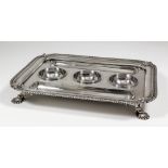A George II silver rectangular ink stand with re-entrance corners, gadroon and leaf mounts, with