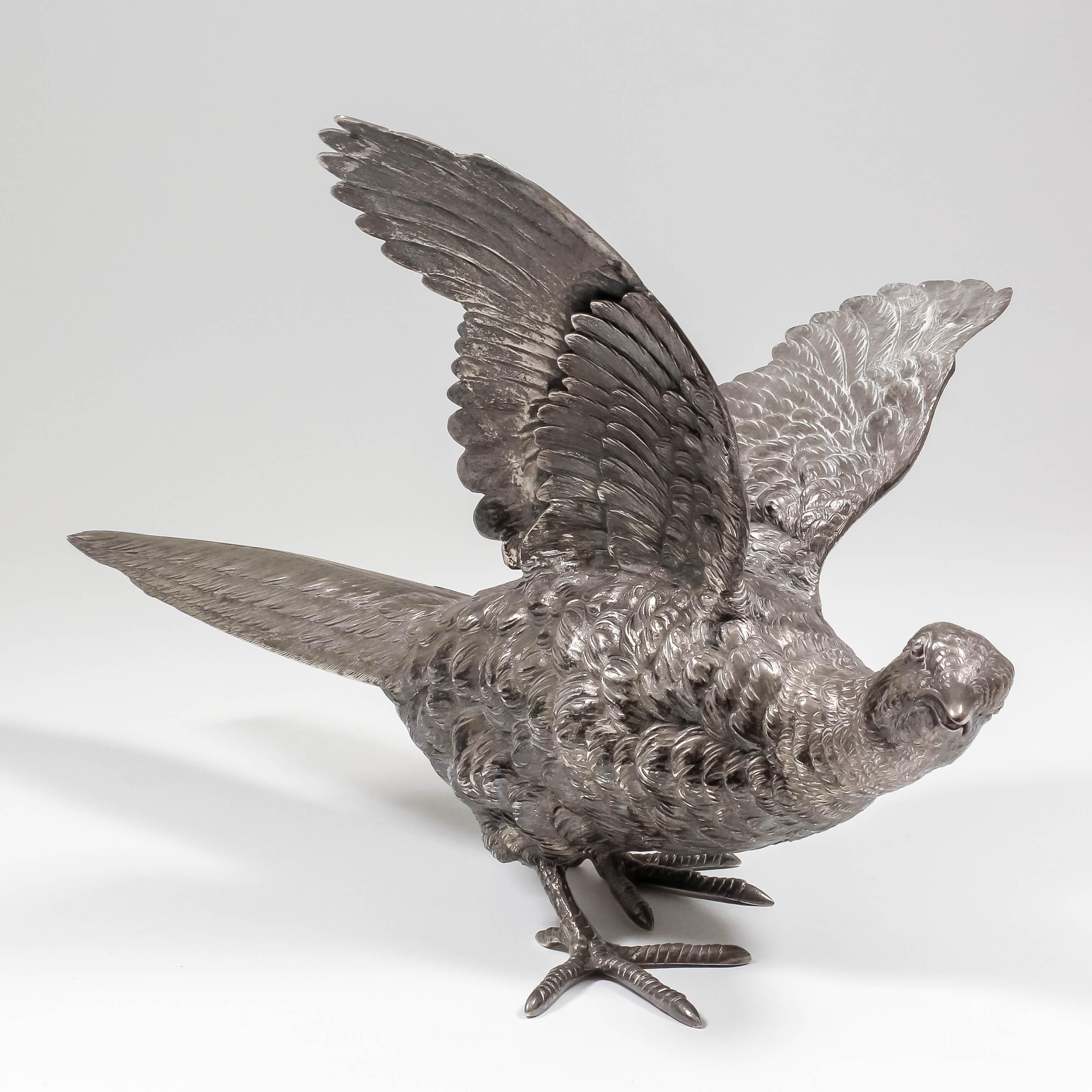 A Continental, possibly French, silvery metal model of a pheasant, 14ins overall x 8.25ins high (