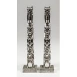 A pair of Elizabeth II cast silver models of totem poles inscribed "Kitimat, British Colombia", each