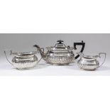 A George V silver three piece tea service of Georgian design, the square rectangular partly reeded