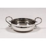 A Charles II silver miniature two-handled taste-vin with shaped and moulded rim and twin wirework