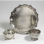 A George V silver circular salver, the shaped and moulded rim with bead and leaf mounts and on