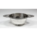A late Victorian silver circular two-handled quaich with moulded rim and pierced handles, 5.75ins