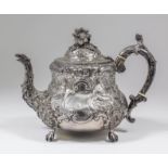 A Victorian silver teapot with squat circular bulbous body, embossed and chased with Chinese