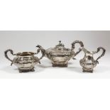 An early Victorian silver circular three piece tea service with leaf mounts, the squat bodies