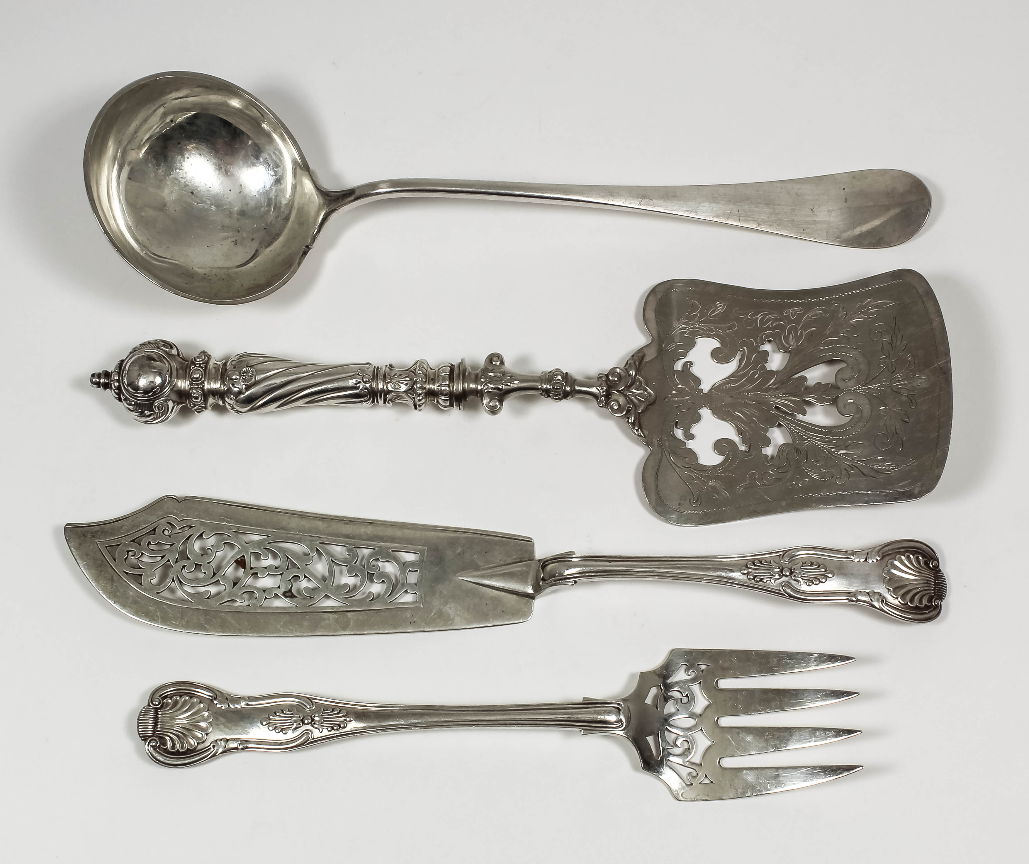 A pair of Victorian silver Kings pattern fish servers, the blades pierced with scroll ornament, by