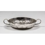 A rare Commonwealth silver circular two-handled taste-vin, the shallow bowl with punched