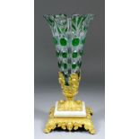 An early 20th Century ormolu mounted green flashed and clear cut-glass flared vase on square