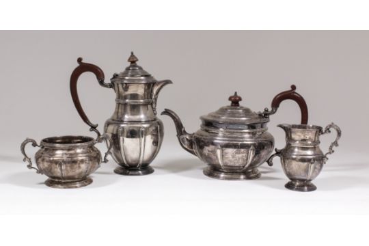 An Edward VII silver four piece tea service of circular form with moulded rims, leaf cast girdles,