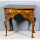 An 18th Century walnut lowboy, the top with wide cross banding, fitted one frieze drawer, later