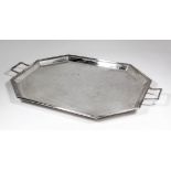 A plain plated octagonal two-handled tray with moulded edge and rectangular loop handles, 25.75ins x