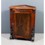 A mahogany and rosewood dwarf bow-front corner cupboard with moulded edge to top enclosed by a