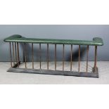 A copper and cast iron rectangular club fender with green leather upholstered and studded top, 66ins