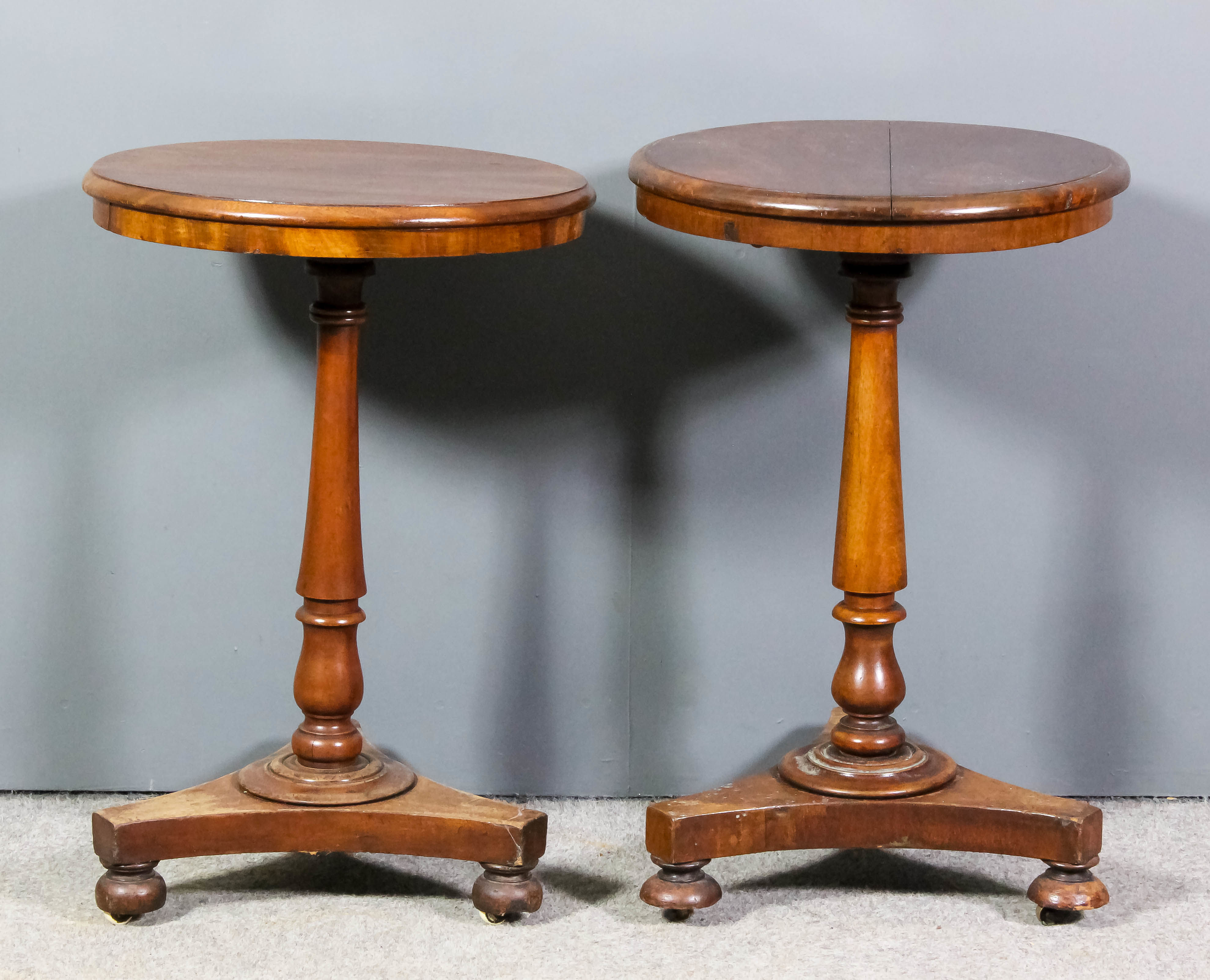 Two Victorian mahogany circular stand tables with moulded edges to top, on turned central columns