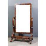 A Victorian mahogany framed rectangular cheval mirror inset with bevelled mirror panel, 43ins x