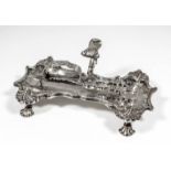 An early George III silver snuffer tray of shaped and moulded outline with leaf cast mounts, C-