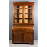 A late Victorian walnut cylinder bureau bookcase, the upper part with moulded cornice, fitted