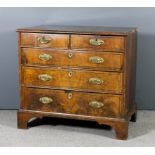 An 18th Century walnut chest, the quarter veneered top inlaid with oval banded panel and