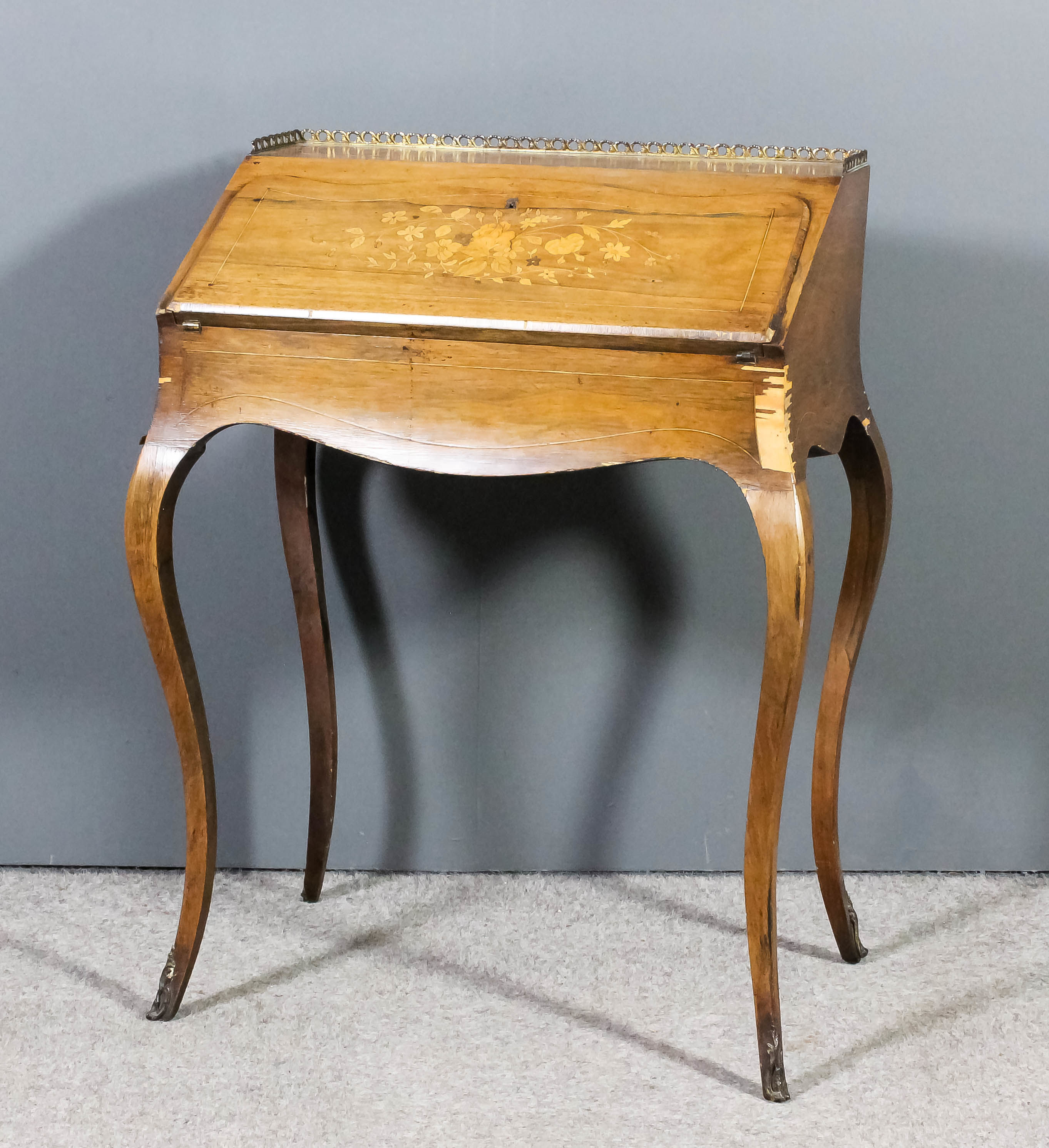 A late 19th Century French lady's rosewood and marquetry bureau with gilt brass gallery to top,