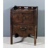 A George III mahogany tray top bedside cabinet, the shaped top with three handle cut-outs enclosed