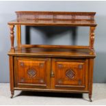 A late Victorian walnut dinner wagon, the upper part with moulded, reeded and carved upstand, on