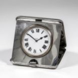 A George V silver cased travelling timepiece, the 2.25ins white enamelled dial with Roman numerals